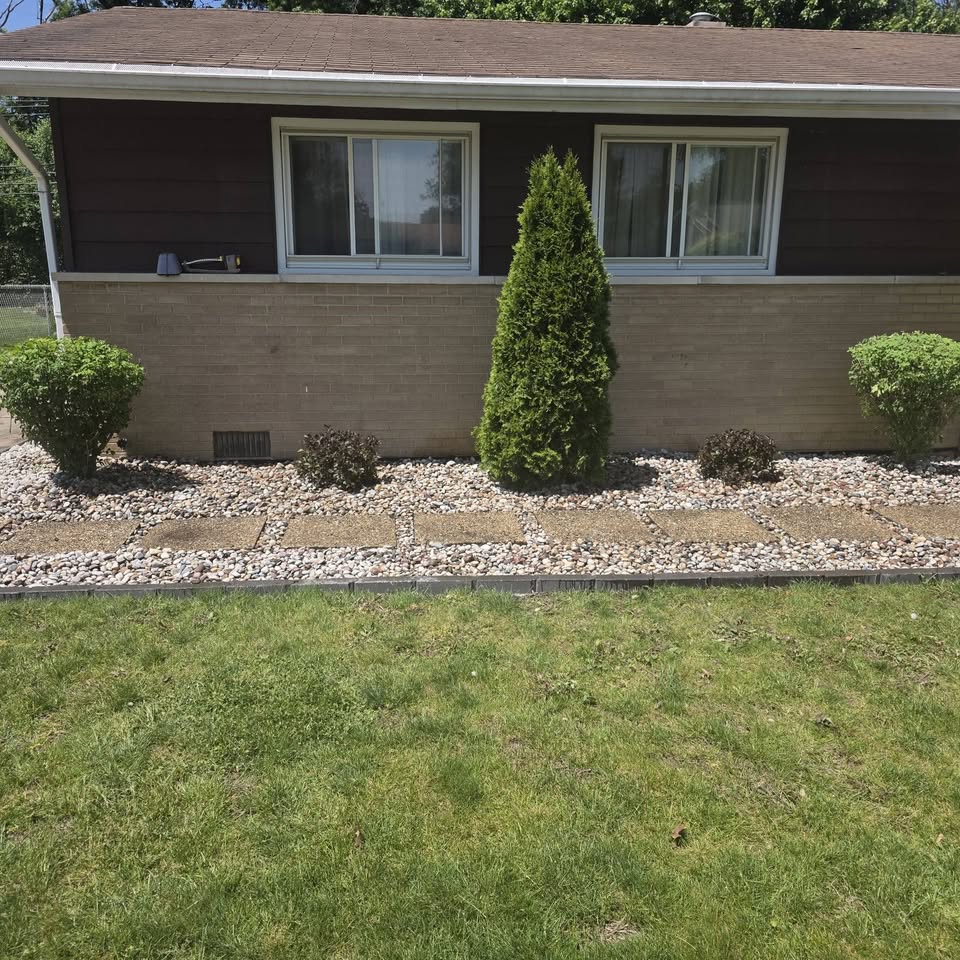 Curb appeal landscaping — rock bed, arborvitae and edging